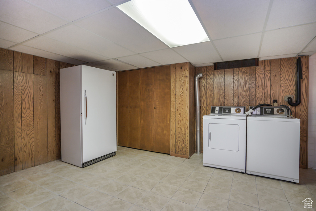 Clothes washing area with washer and clothes dryer and wooden walls