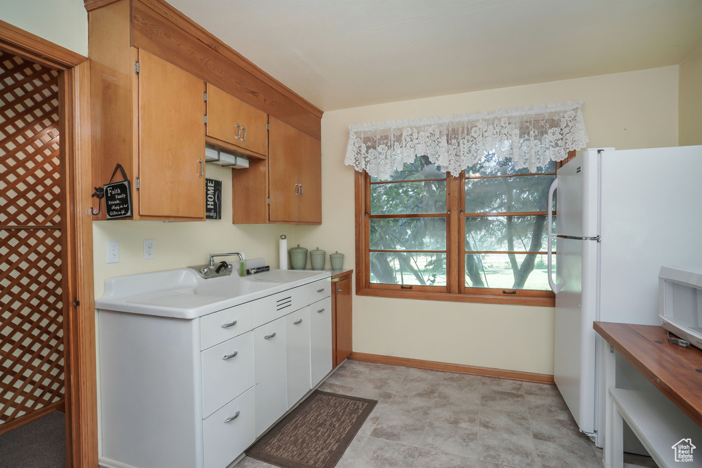 Kitchen featuring white refrigerator