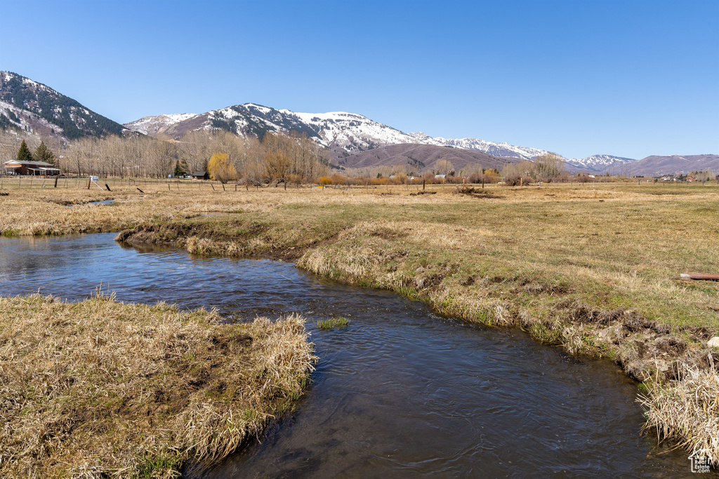 Water view featuring a mountain view and a rural view