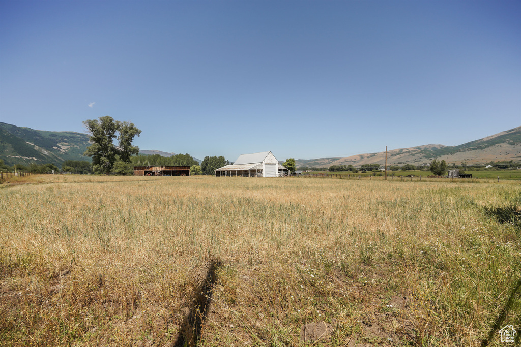 View of yard featuring a rural view and a mountain view