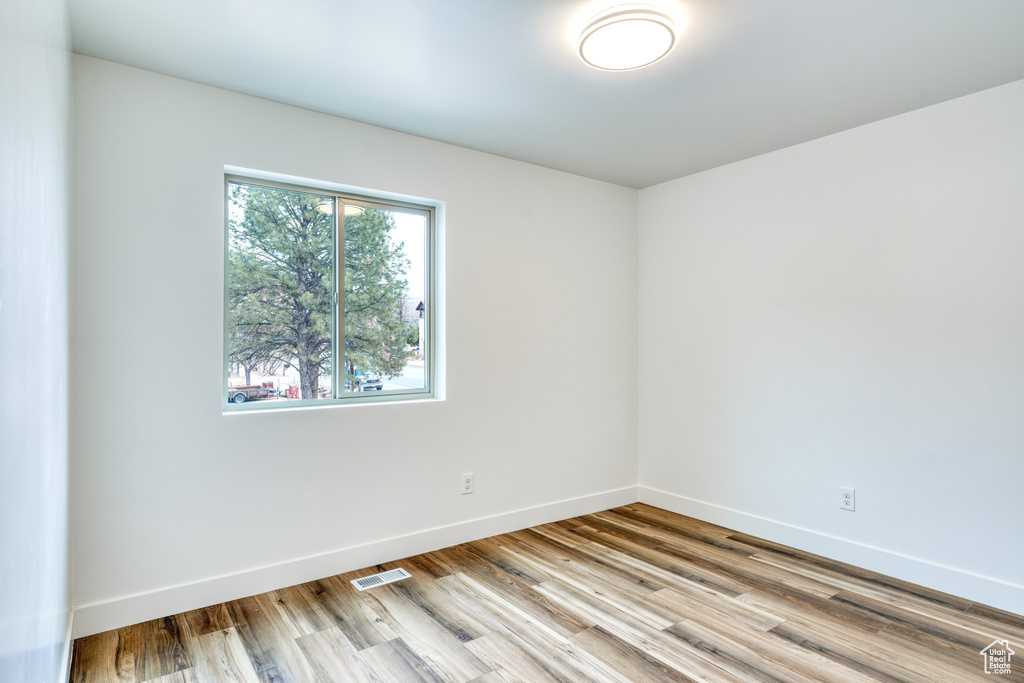 Unfurnished room with light hardwood / wood-style floors