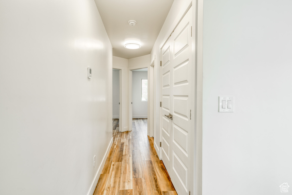 Corridor featuring light wood-type flooring