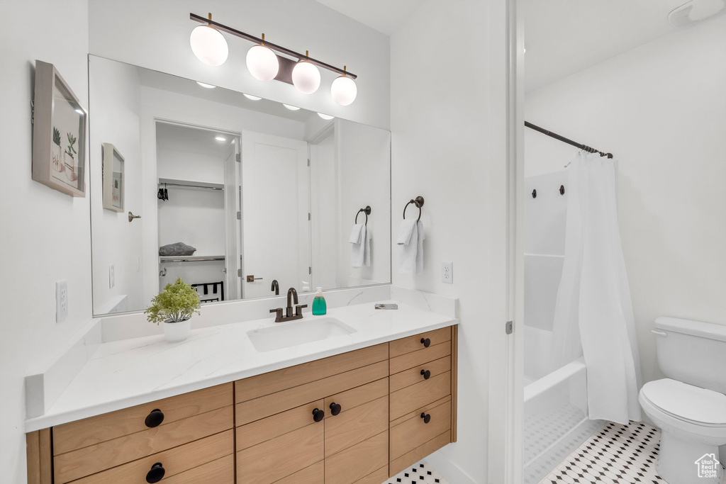 Full bath with vanity, shower / tub combo with curtain, and tile patterned floors
