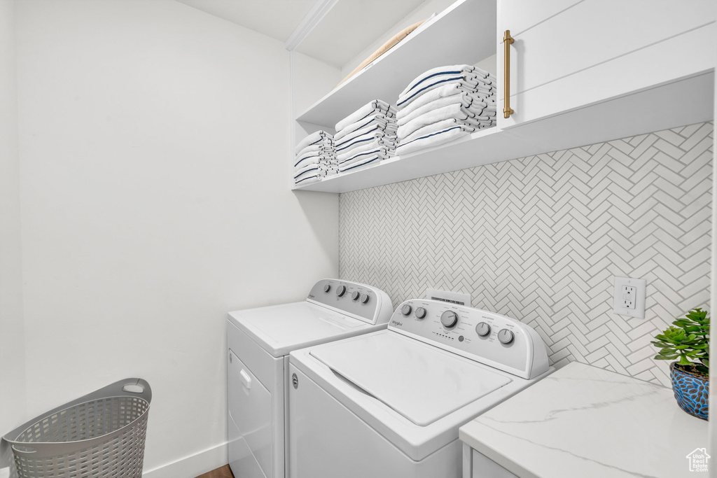 Washroom featuring washing machine and clothes dryer