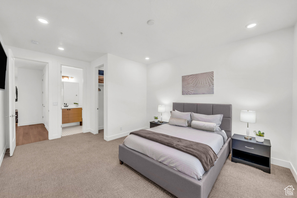 Bedroom featuring carpet, recessed lighting, and connected bathroom
