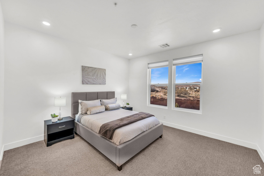 Carpeted bedroom with recessed lighting and baseboards