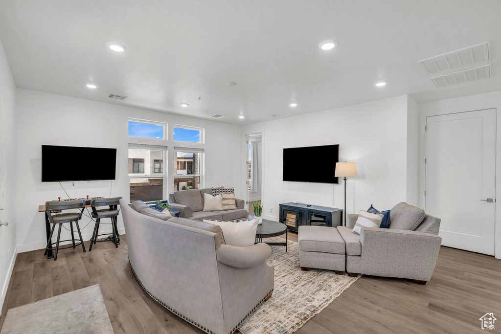 Living room with wood finished floors and recessed lighting
