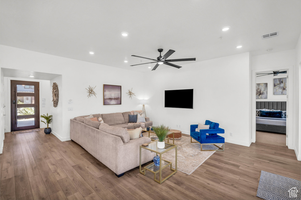 Living room featuring a ceiling fan, wood finished floors, and recessed lighting