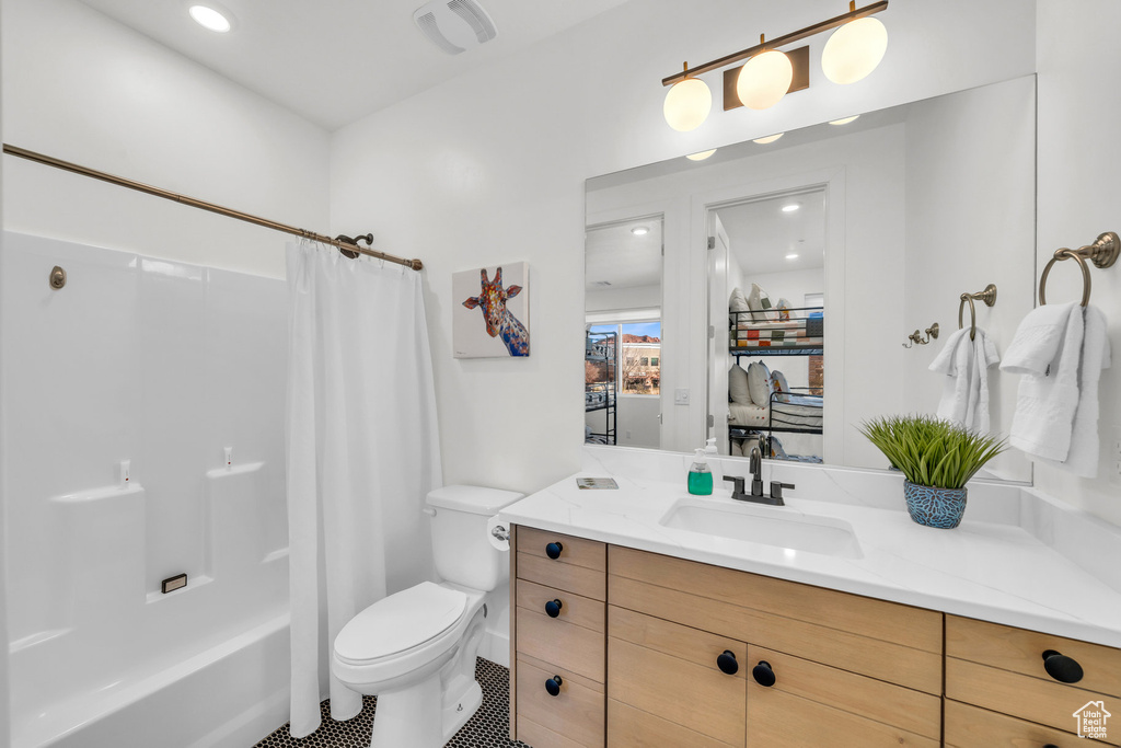 Full bathroom featuring vanity, shower / tub combo with curtain, and recessed lighting