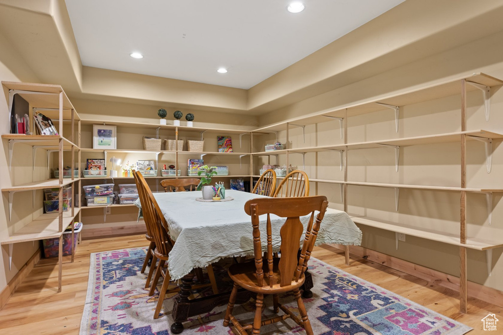 Dining area with wood finished floors and recessed lighting