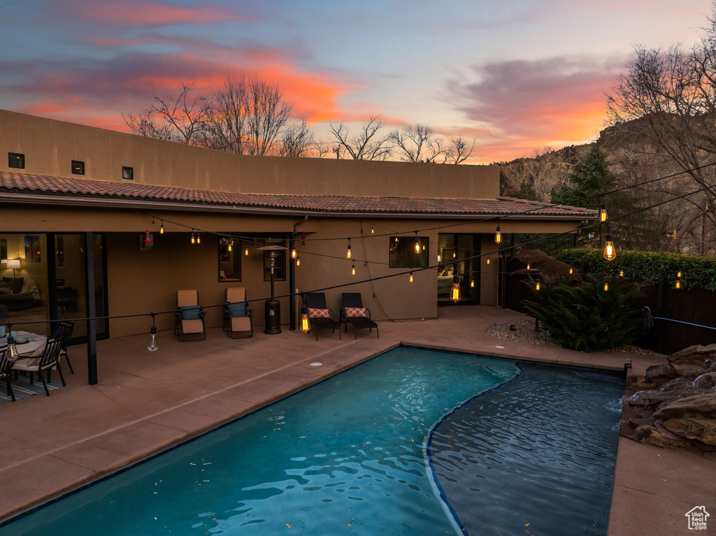 View of pool featuring a patio, fence, and a mountain view