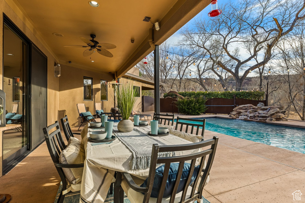View of patio featuring a fenced backyard, ceiling fan, and outdoor dining space