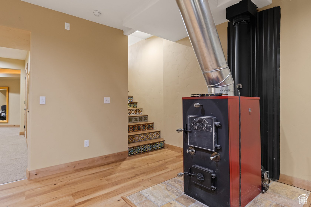Below grade area featuring wood finished floors, baseboards, and stairway