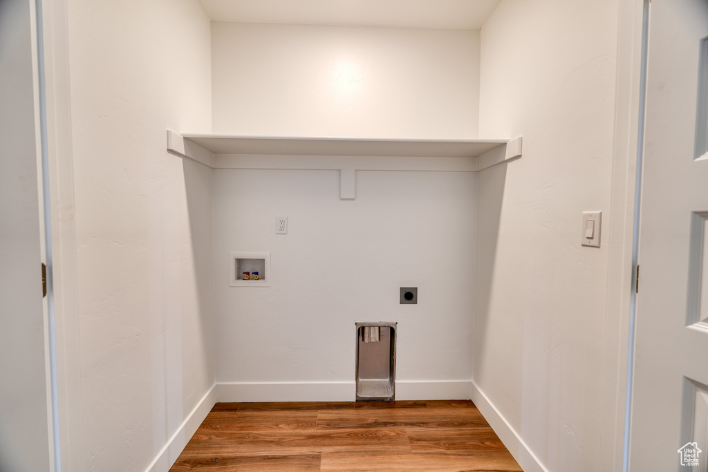 Laundry room featuring washer hookup, hookup for an electric dryer, and light hardwood / wood-style flooring