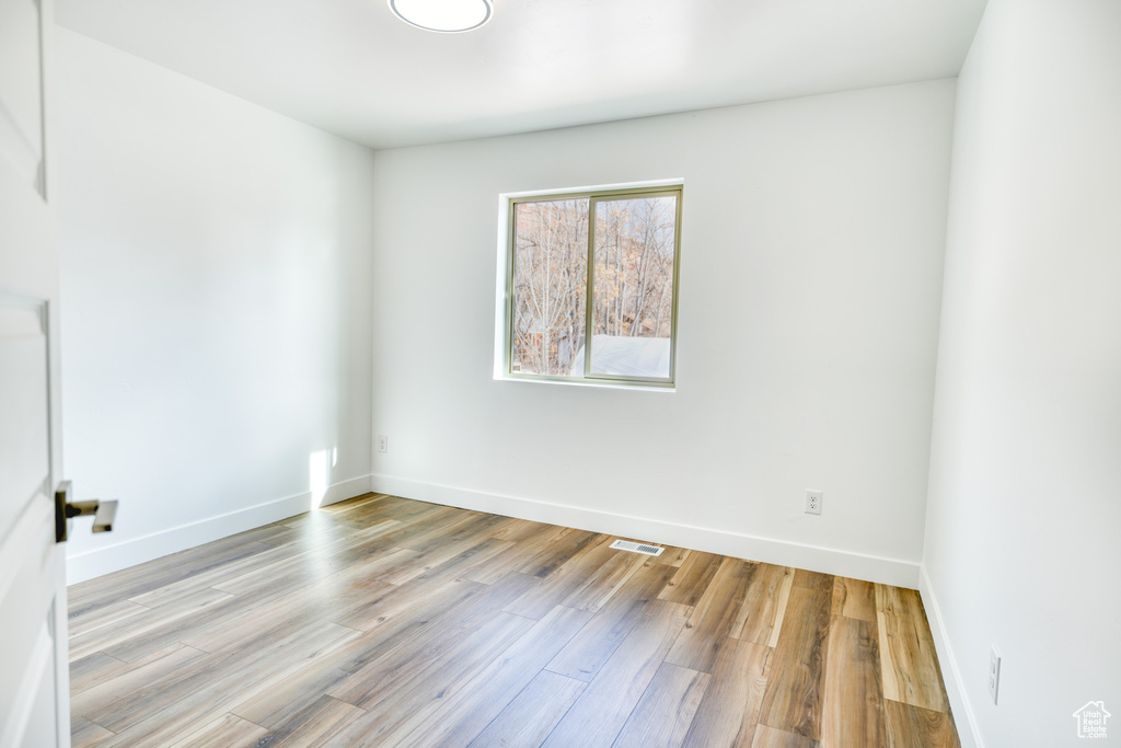 Unfurnished room with light wood-type flooring