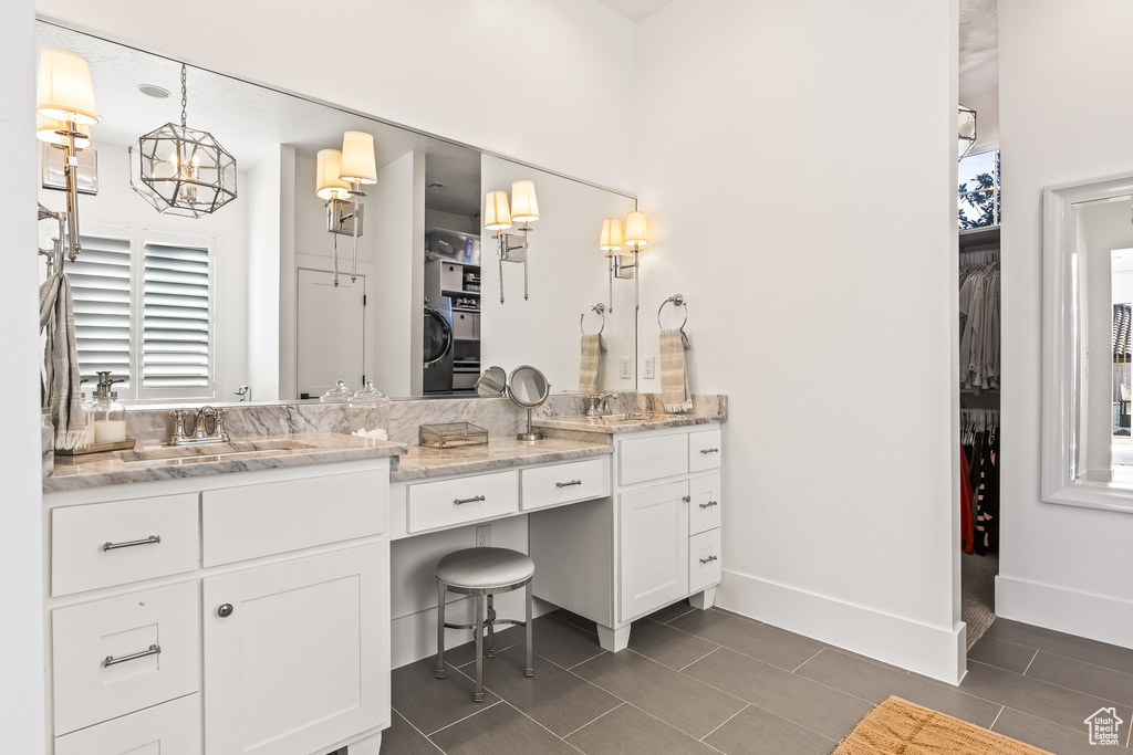 Bathroom featuring vanity, tile patterned flooring, and washer / dryer