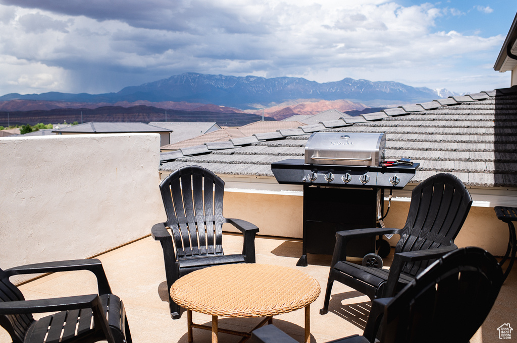 View of patio featuring a mountain view and grilling area