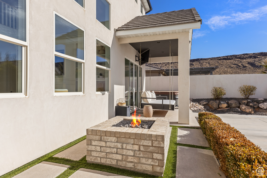 View of patio with a fire pit