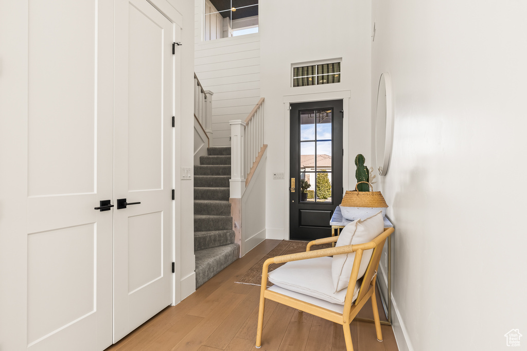 Entryway featuring wood-type flooring and a high ceiling