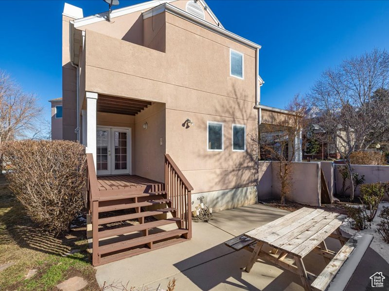 Back of property with french doors and a patio area