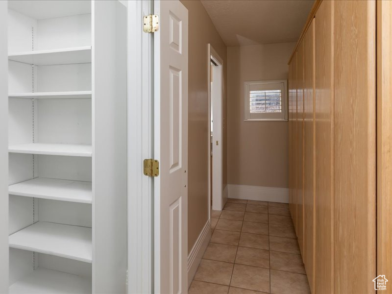 Hallway with light tile patterned floors