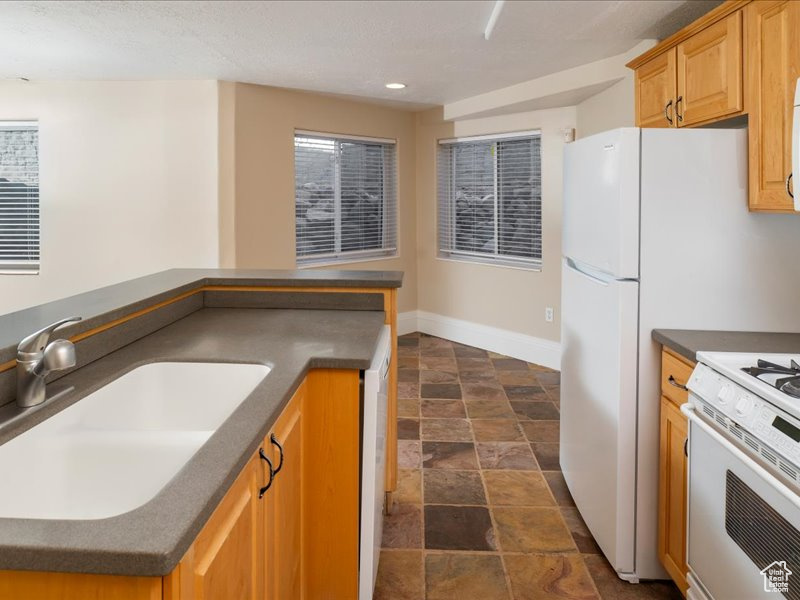 Kitchen with white range and sink