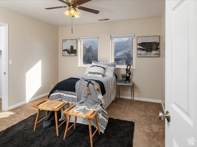 Bedroom featuring ceiling fan and carpet floors