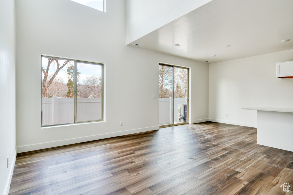 Unfurnished living room featuring hardwood / wood-style floors