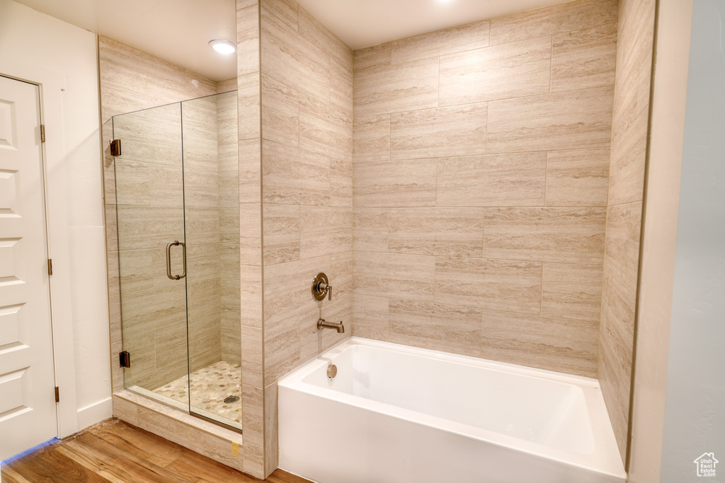 Bathroom featuring separate shower and tub and hardwood / wood-style floors