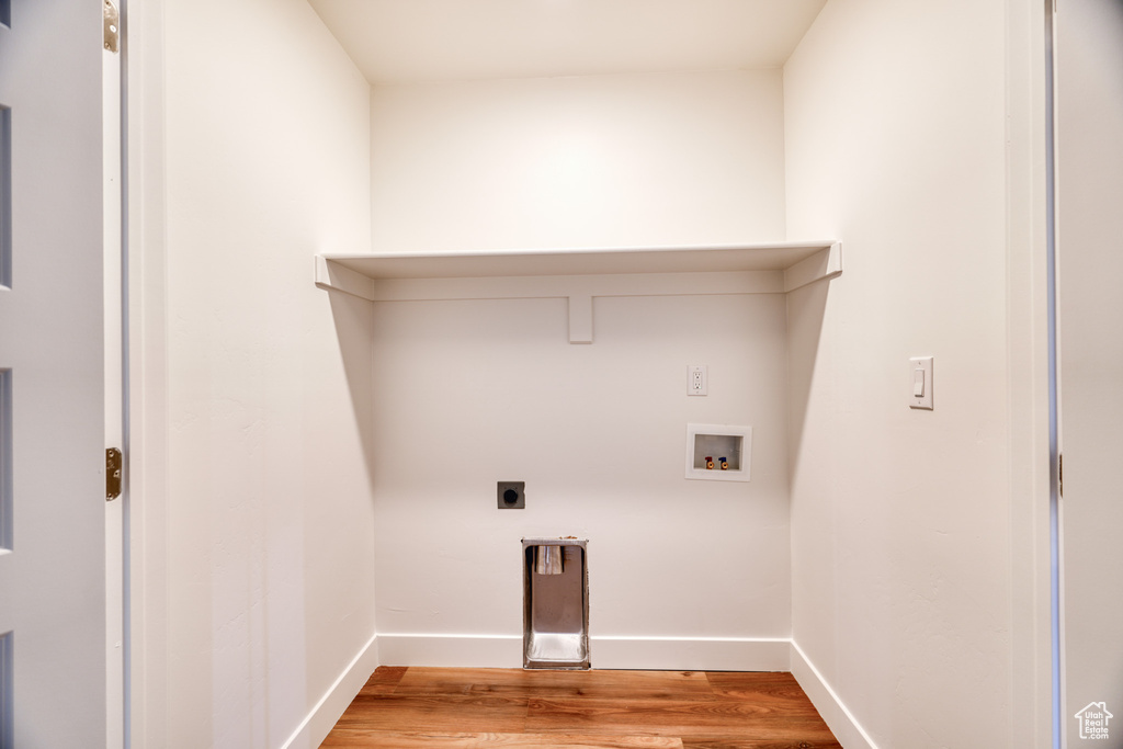 Laundry area with electric dryer hookup, washer hookup, and light hardwood / wood-style floors