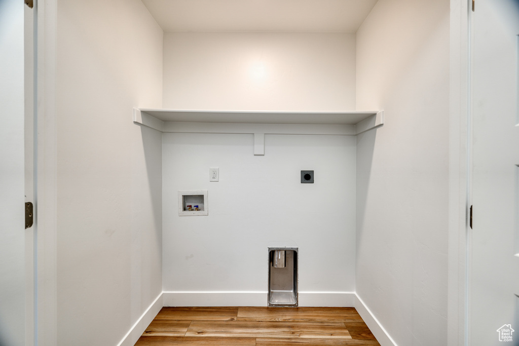 Laundry room featuring hookup for a washing machine, hookup for an electric dryer, and light wood-type flooring
