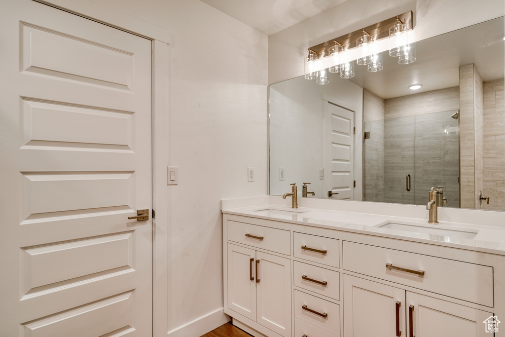 Bathroom with vanity and a shower with shower door