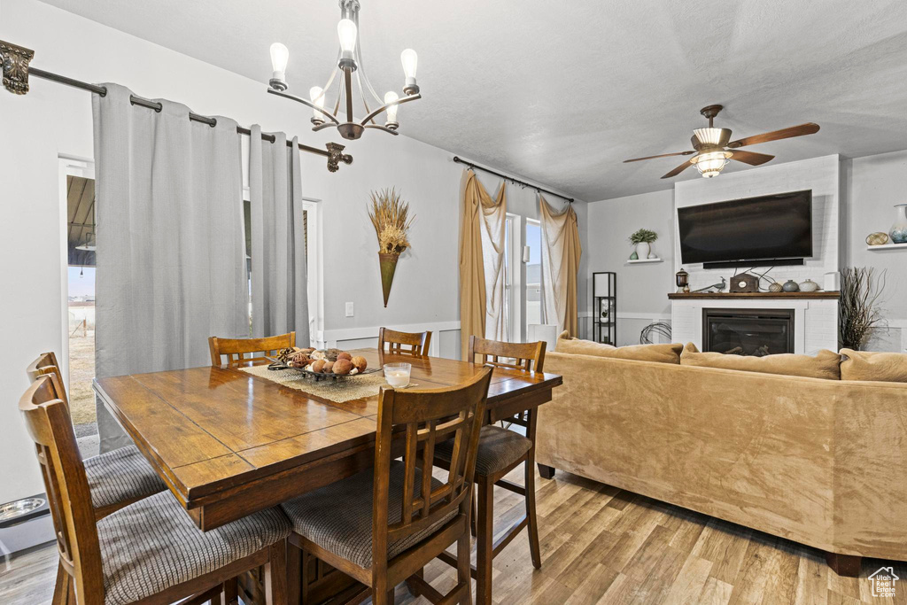 Dining room with ceiling fan and light wood-type flooring