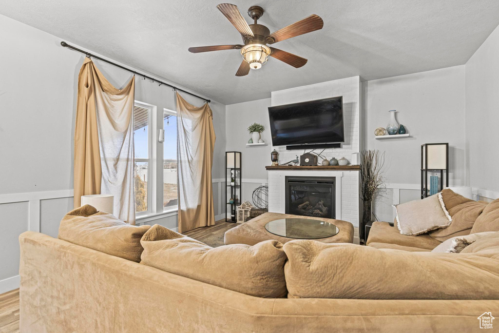 Living room featuring hardwood / wood-style flooring and ceiling fan
