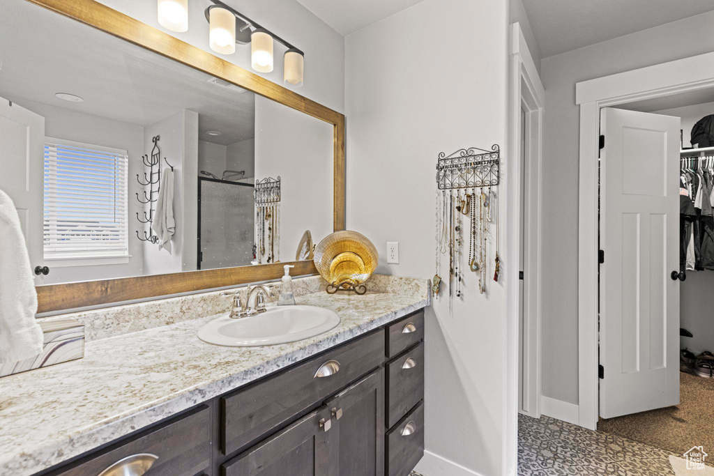 Bathroom with vanity and a shower