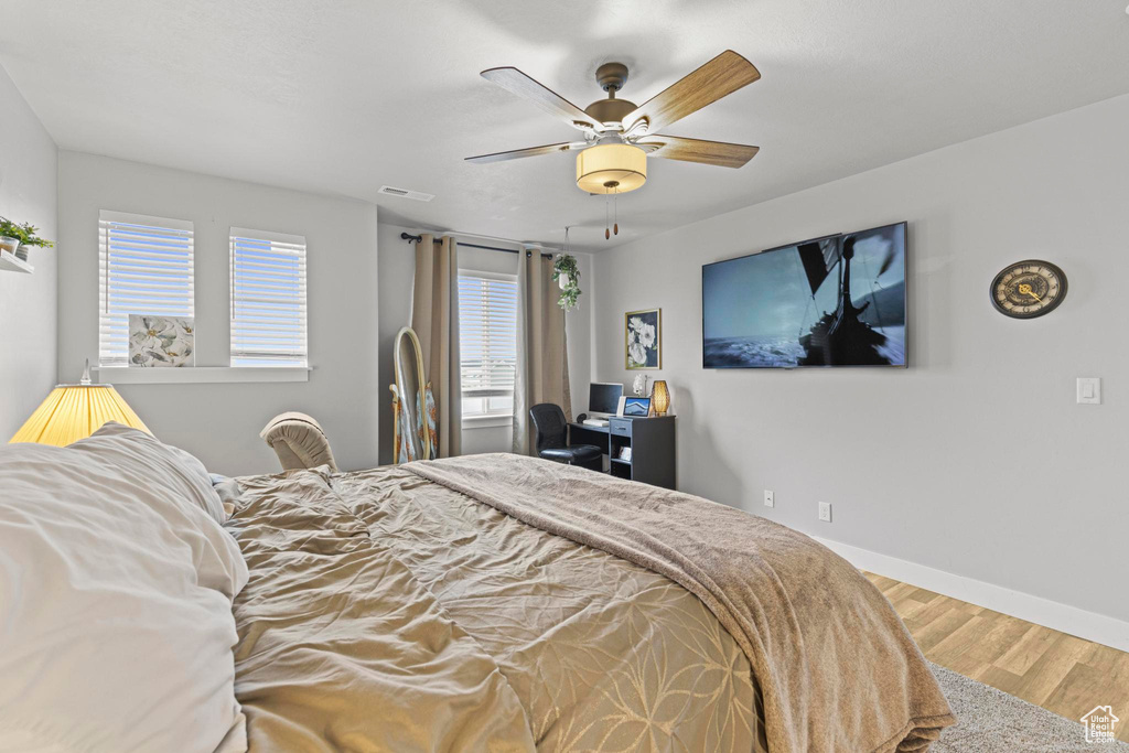 Bedroom with wood-type flooring and ceiling fan