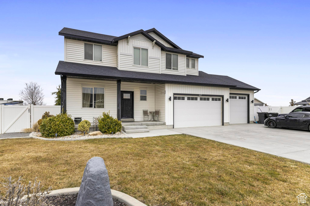 View of front of home featuring a garage and a front lawn