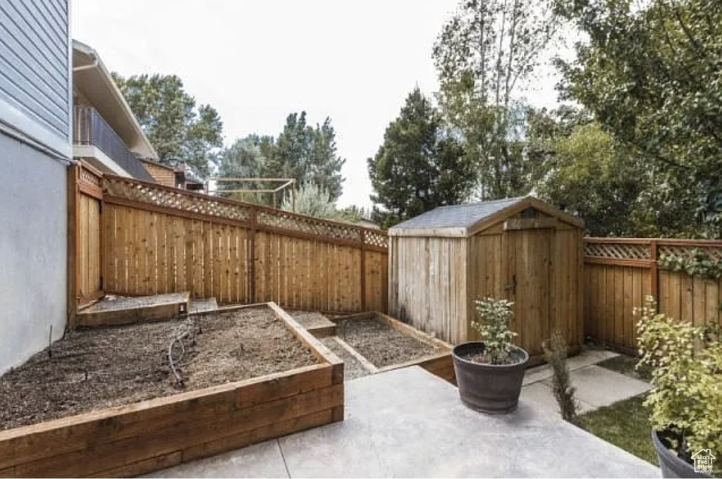 View of patio with a storage unit