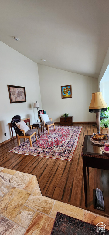 Sitting room with hardwood / wood-style floors and vaulted ceiling