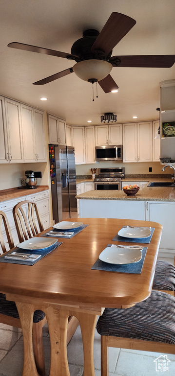 Unfurnished dining area with ceiling fan and sink