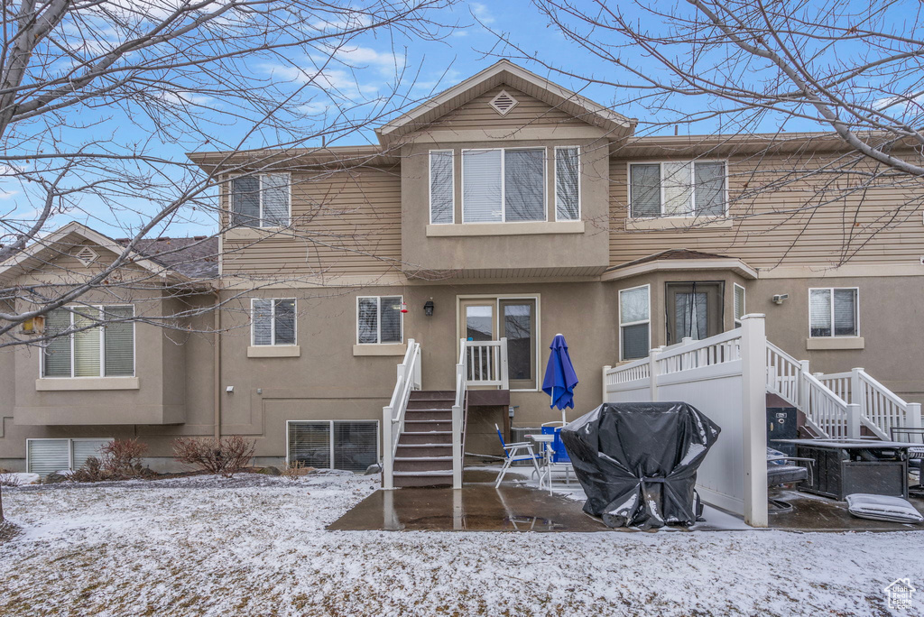 View of snow covered rear of property