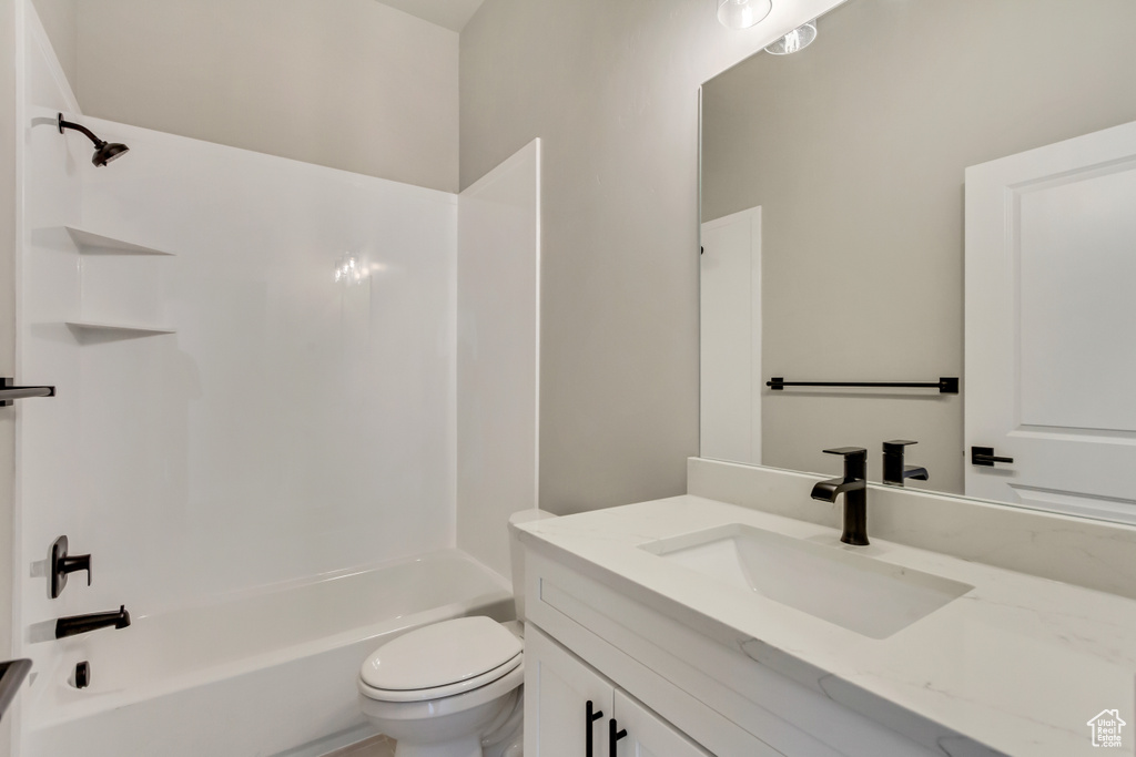 Full bathroom featuring vanity, toilet, and  shower combination
