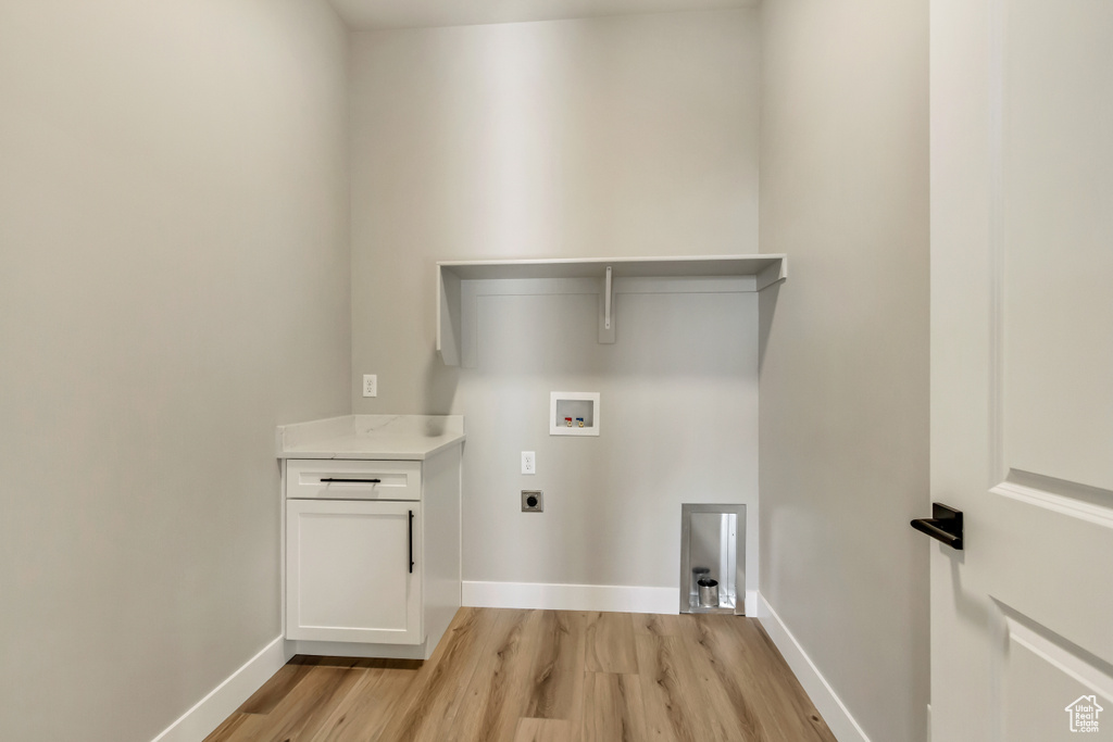 Washroom featuring hookup for a washing machine, electric dryer hookup, and light hardwood / wood-style flooring
