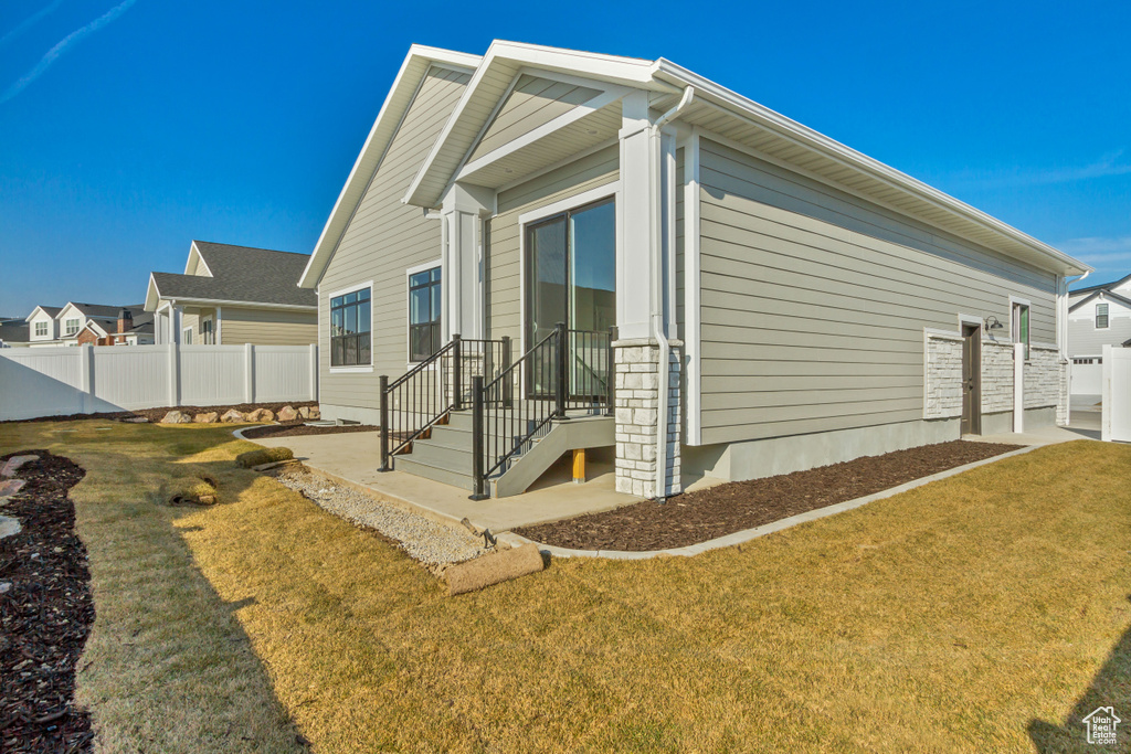 View of side of property featuring a lawn