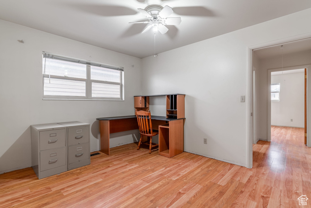 Home office featuring light hardwood / wood-style floors and ceiling fan