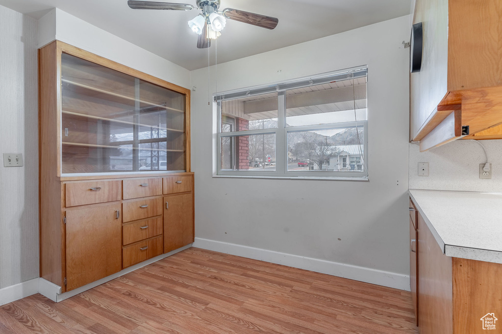 Unfurnished dining area featuring light hardwood / wood-style flooring and ceiling fan