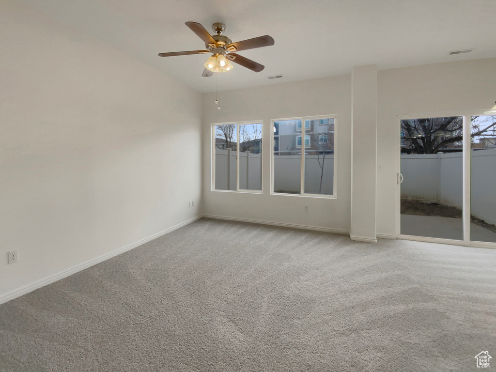 Empty room with ceiling fan and carpet flooring