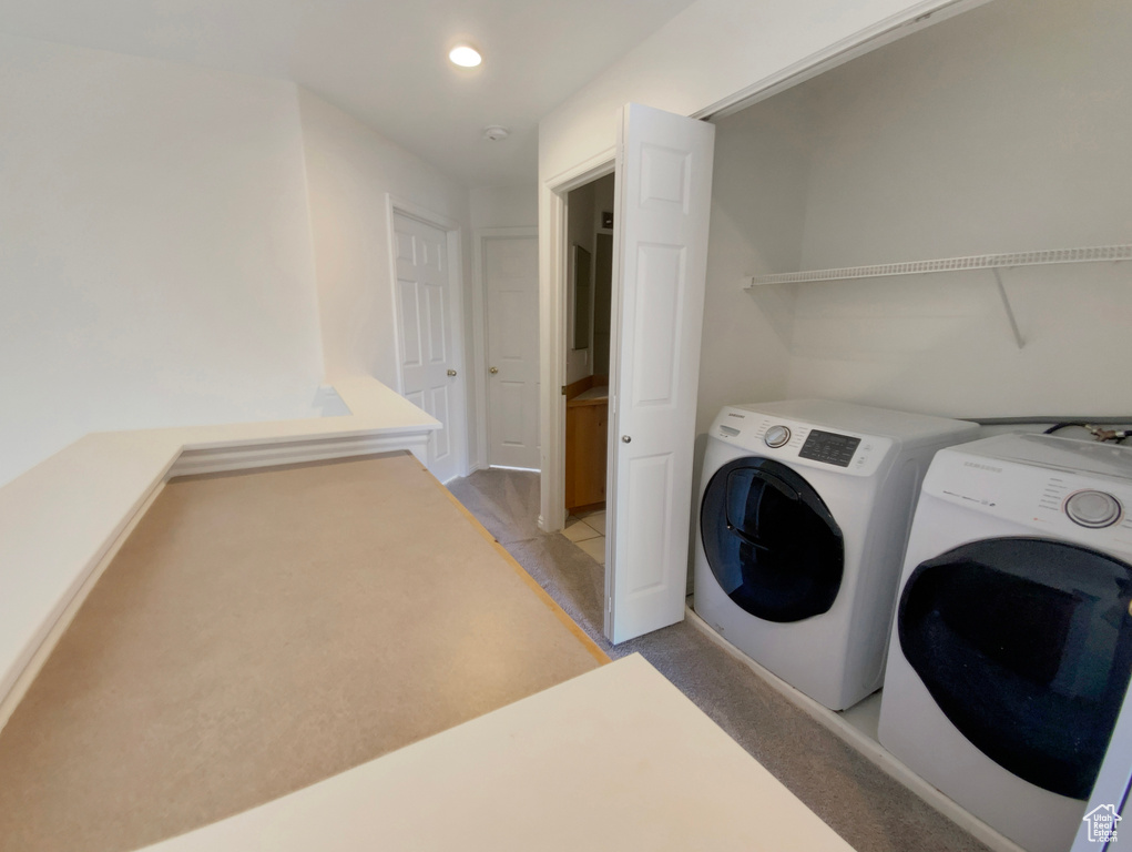 Clothes washing area featuring washing machine and clothes dryer