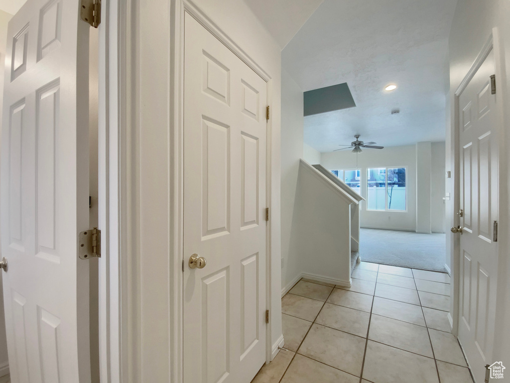 Hallway with light tile patterned floors