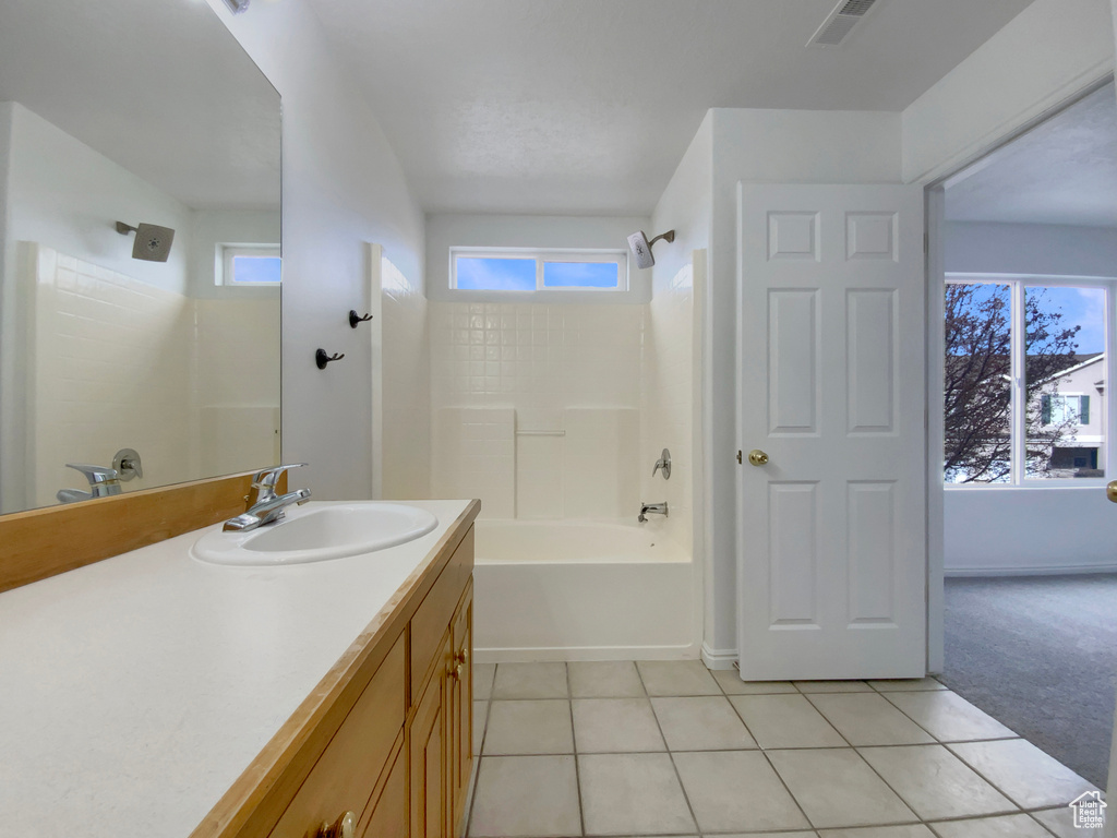 Bathroom with tile patterned flooring, vanity, and bathtub / shower combination